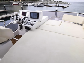A sleek view of the helm and seating area inside a modern boat, showcasing the sophisticated console and comfortable layout, perfect for a day on the water.
