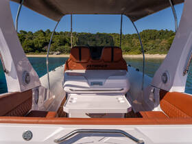 A stylish interior view of a Stinger boat showcasing comfortable seating and a well-designed helm area, perfect for a day out on the water.