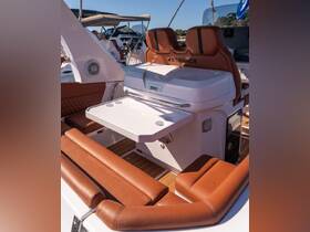 A stylish interior view of a Stingher boat showcasing comfortable seating and a well-designed helm area, perfect for relaxing and enjoying time on the water.
