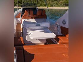 The interior of a stylish boat featuring a modern helm and comfortable seating, perfect for a day on the water.