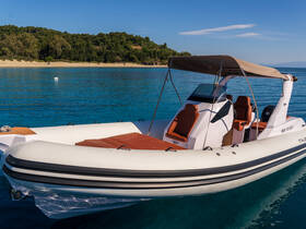 A sleek speedboat docked in crystal-clear waters, showcasing its modern design and comfortable seating, perfect for a day on the water.