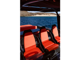 Interior view of a modern boat featuring sleek red seating and a spacious helm area, perfect for comfortable cruising on the water.
