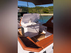 A well-designed interior view of a boat's helm and seating area, showcasing modern amenities and a stylish layout, perfect for comfortable cruising.