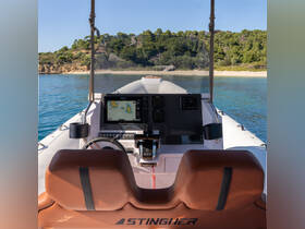 The interior view of a sleek boat helm showcases modern navigation equipment and comfortable seating, perfect for a day on the water.