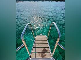 An unclear view of a boat ladder leading into sparkling turquoise waters, ideal for swimming or water activities.
