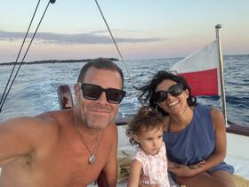 A joyful family enjoys a sunset boat ride, capturing smiles and precious moments on the water.