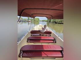 A cozy interior view of a boat featuring comfortable seating, with a parent and child enjoying a peaceful moment on the water.