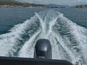 A dynamic view from the back of a motorboat, showcasing the powerful wake as it glides through clear waters, perfect for exploring coastal destinations.