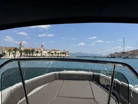 A scenic view from the bow of a boat, showcasing a charming waterfront with palm trees and historic buildings, perfect for exploring coastal destinations.
