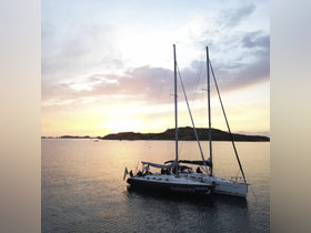 A beautiful sailboat docked at sunset, showcasing its elegant lines against a serene backdrop — perfect for romantic evening cruises or sailing adventures.