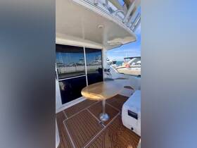 Interior view of a boat's dining area featuring a polished wooden table and comfortable seating, perfect for enjoying meals while cruising.