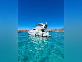 A stunning yacht anchored in crystal-clear waters, showcasing its elegant design against a backdrop of blue skies and rocky shores.