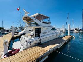 A stunning yacht docked at a marina under clear blue skies, showcasing its elegant design and inviting atmosphere for luxury boating experiences.