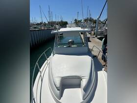 A clear view of the front deck of a boat docked at the marina, showcasing its sleek design and inviting seating area.