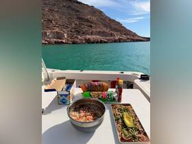 A beautifully arranged spread of snacks and dishes on a boat, perfect for enjoying a meal while taking in the scenic views of the surrounding landscape.