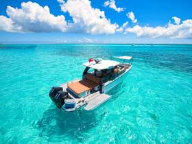 A stunning view of a boat cruising through crystal-clear turquoise waters, perfect for exploring beautiful destinations and enjoying the sun.