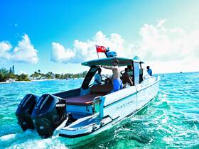 A lively group enjoys a day on the water aboard a sleek boat, showcasing the excitement of ocean adventures and camaraderie.