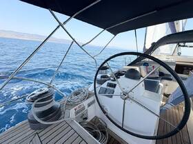 A detailed view of the helm inside a sailing yacht, showcasing the steering wheel and control panel, perfect for navigating the open waters.
