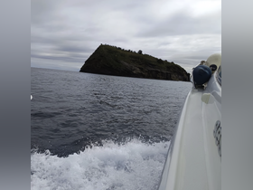 A scenic view of a rocky island from a boat, showcasing the beauty of the ocean and the surrounding landscape — perfect for adventure seekers and nature lovers.