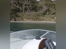 A scenic view from the bow of a boat, showcasing a beautiful coastline and beach, perfect for exploring hidden gems along the shore.