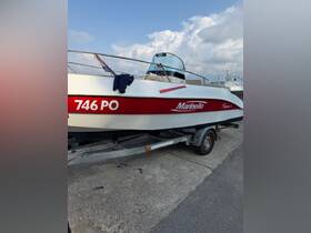 A close-up view of a Marinello boat docked and ready for adventure, showcasing its sleek design and vibrant colors.