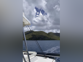 A scenic view from the deck of a yacht, showcasing the lush green hills and tranquil waters — perfect for exploring the beauty of nature while sailing.