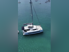 Aerial view of a Bali 46 catamaran cruising in clear turquoise waters, showcasing its sleek design and spacious layout, perfect for group charters.