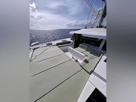 A spacious lounge area on a yacht, featuring comfortable seating and stunning ocean views — perfect for relaxation while cruising.