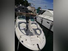 A well-equipped boat interior showcasing comfortable seating and a helm, perfect for a day on the water.