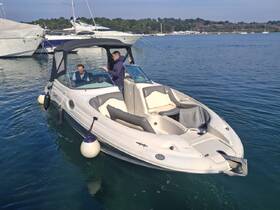 Two individuals navigate a boat in calm waters, showcasing the joy of boating adventures and on-water experiences.
