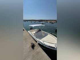 A sleek speedboat docked at the marina, showcasing its clean lines and inviting design, perfect for a day out on the water.