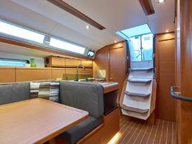 Interior view of a modern boat cabin featuring comfortable seating and a well-equipped helm area, perfect for relaxing during your nautical adventures.
