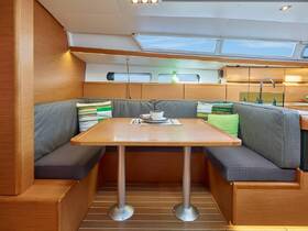 A cozy dining area inside a boat featuring comfortable seating and a stylish table, perfect for enjoying meals while cruising.