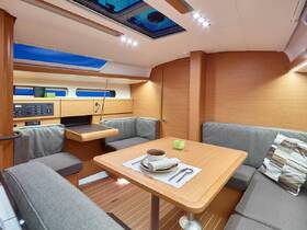 A cozy interior view of a boat's cabin featuring comfortable seating and a dining area, perfect for relaxing and enjoying meals while at sea.