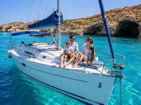 A family enjoys a sunny day sailing on a beautiful blue sea, creating unforgettable memories aboard their Beneteau yacht.