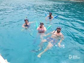 A lively group enjoys snorkeling in crystal-clear waters, showcasing the fun and excitement of underwater exploration.