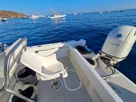 A view of the interior seating area of a boat, showcasing the helm and a clean, functional design — perfect for fishing or leisure outings on the water.