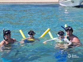 A joyful family enjoys snorkeling in crystal-clear waters, creating unforgettable memories during their aquatic adventure.