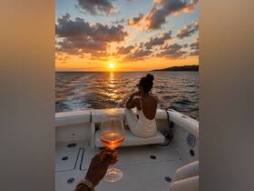 A romantic sunset cruise featuring a couple toasting with rosé on a boat, creating the perfect backdrop for special moments on the water.