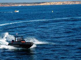 A speedboat navigates through the vibrant blue waters, showcasing the thrill of boating adventures on the open sea.