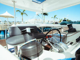 A well-equipped helm area inside a boat, showcasing the steering console and seating, perfect for navigating the waters in style.