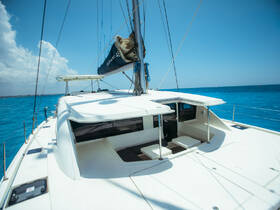 A sleek catamaran sailing through vibrant blue waters, showcasing its elegant design and spacious deck, perfect for leisurely cruises.