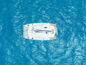 Aerial view of a sleek catamaran gliding through vibrant turquoise waters, perfect for exploring coastal destinations.