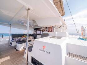 A spacious interior view of a Fountaine Pajot catamaran, showcasing comfortable seating and a well-designed cabin area, perfect for relaxation while cruising.