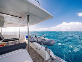 A serene view of the interior of a catamaran, showcasing comfortable seating and a well-designed cabin space, perfect for relaxing while cruising on the open water.