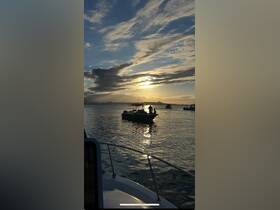 A picturesque sunset scene featuring boats on the water, capturing the serene beauty of a boating experience at dusk.