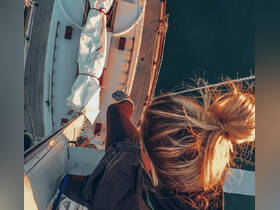 A thrilling perspective of a person climbing the mast of a sailboat, showcasing the adventurous spirit of sailing and the breathtaking views from above.
