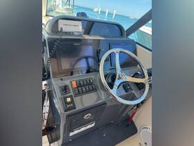 A detailed view of the helm and console area of a boat, showcasing the navigation equipment and controls, perfect for understanding the vessel's operational features.