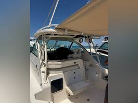 Interior view of a boat's helm and seating area, showcasing a comfortable and stylish space for navigation and relaxation.