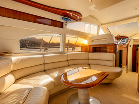 A beautifully designed interior of a yacht featuring a spacious seating area and elegant finishes, perfect for relaxing while enjoying scenic views.
